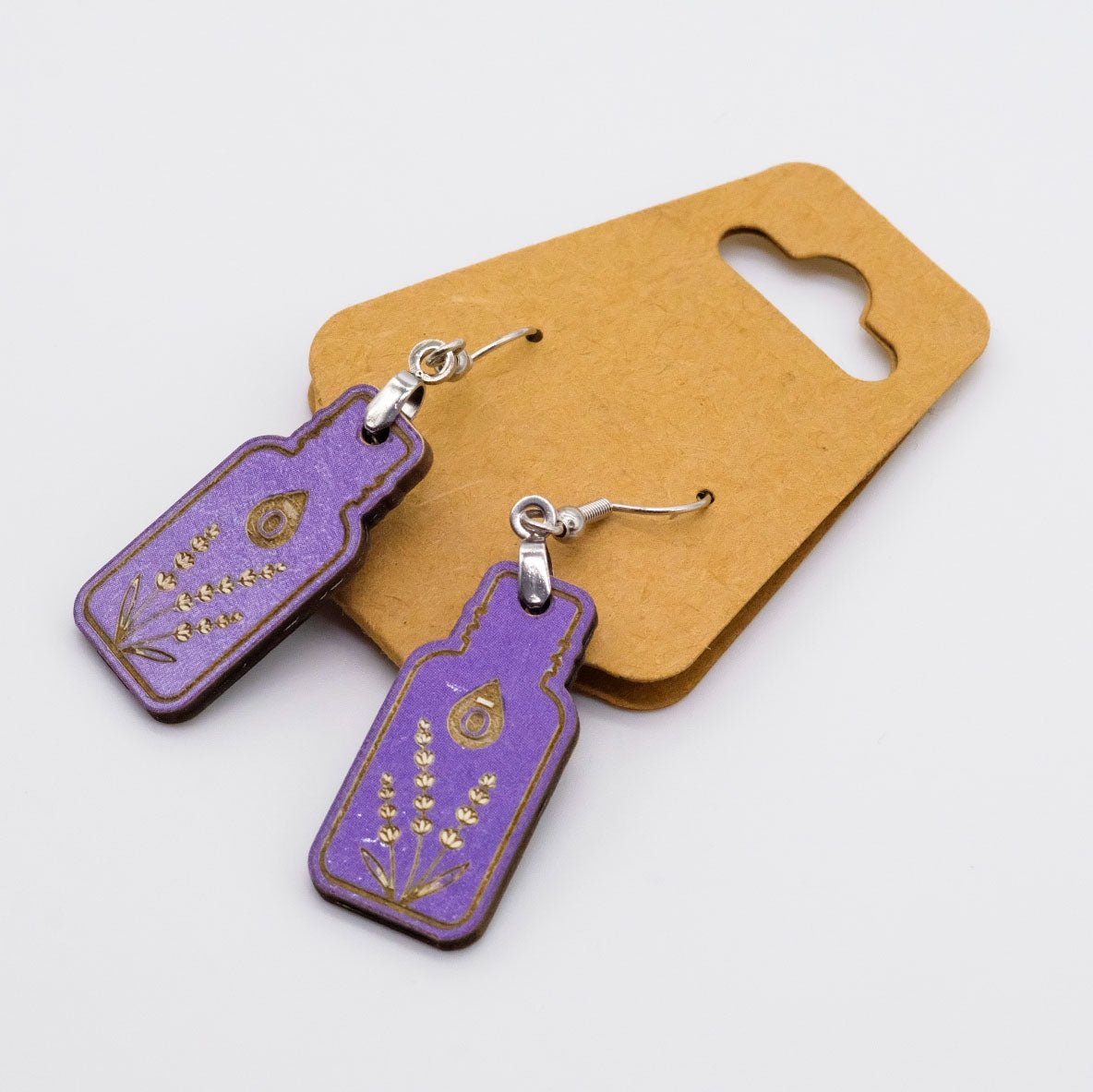 Boucles d’oreilles violettes en forme de bouteille d’huile essentielle