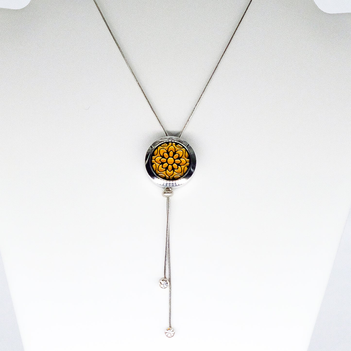Round stainless steel aromatherapy necklace with a long chain 