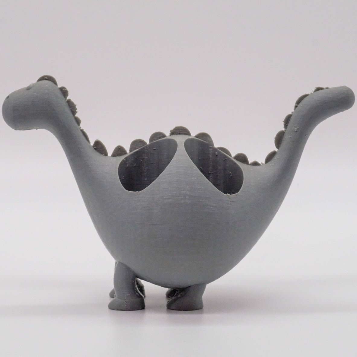 Présentoir en forme de dinosaure coloré