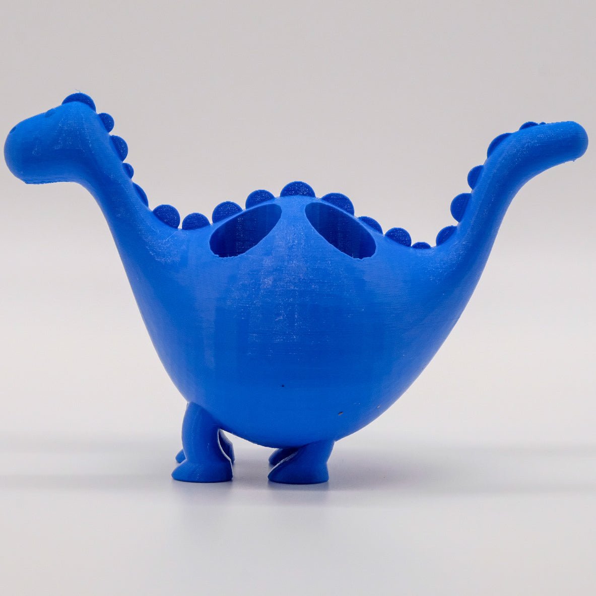 Présentoir en forme de dinosaure coloré