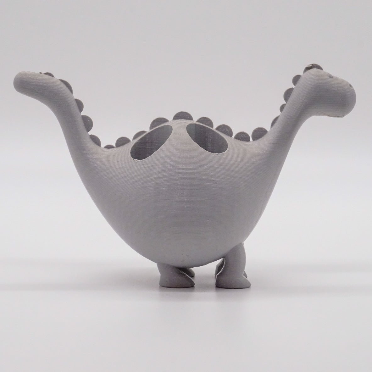 Présentoir en forme de dinosaure coloré